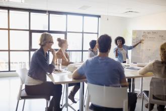 Conference table and people sitting around it